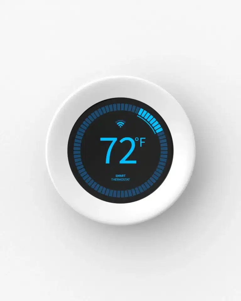 A white smart thermostat, expertly installed in Nashville, TN, displays a comfortable temperature of 72°F on the wall, ensuring optimal air conditioning.